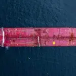 Aerial view crude oil tanker ship at sea^ Red crude oil tanker ship top view^ Logistic and maritime transpoprtation of petroleum^ Modern offshore terminal loading tanker ship.