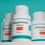 Mifepristone tablets in bottle. RU-486 Medical abortion pills. Used in combination with misoprostol. 3D illustration.