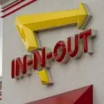 In-N-Out Burger sign is seen at the entrance to its restaurant in Grants Pass^ Oregon. In-N-Out Burger is an American fast food chain based in Irvine^ California.