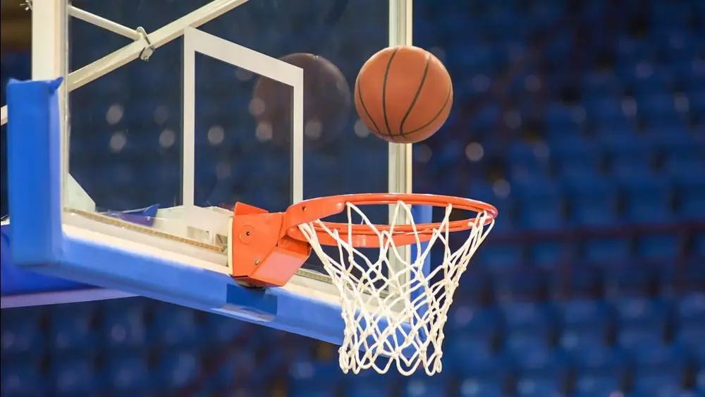 A basketball flying into the basket