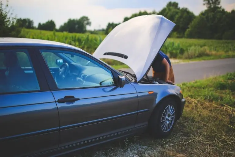 man-checking-his-dead-car-for-battery-or-starter-issues-768x512
