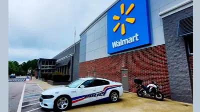 Police car parked in front of Walmart Store^ Fayetteville^ North Carolina^ USA^ August 6^ 2025