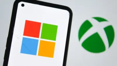 Microsoft logo on a smartphone screen and Xbox logo in the background. Indonesia - June 12^ 2025