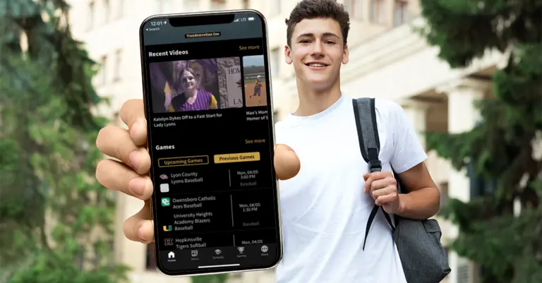 high school student holding phone with sports app