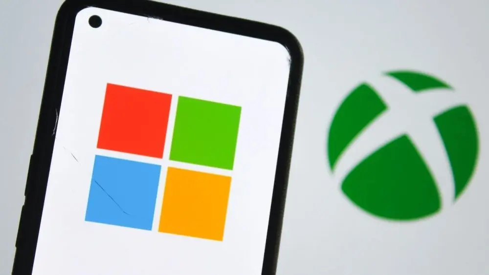 Microsoft logo on a smartphone screen and Xbox logo in the background. Indonesia - June 12^ 2025