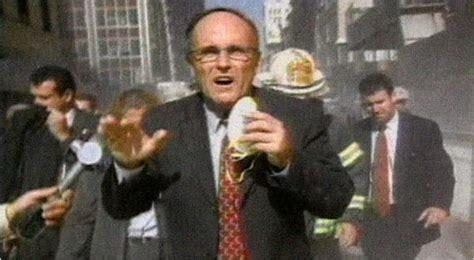 Rudy Giuliani at Ground Zero with smoke billowing behind him