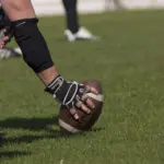 football-player-holding-football-on-grass-generic-e1459896025823-1024x1007