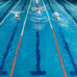 five-swimmers-racing-against-each-other-swiming-pool_171337-7818