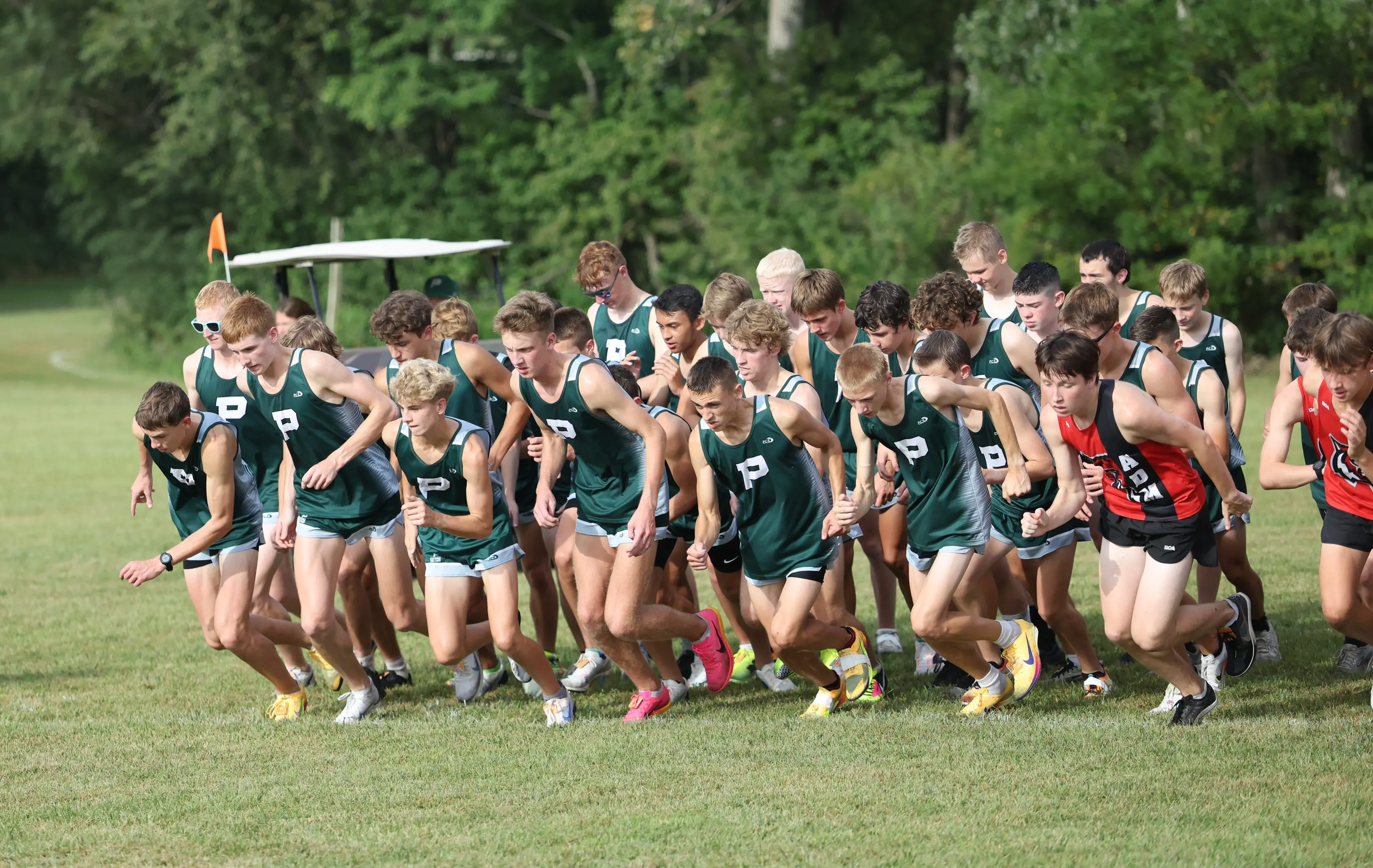 Pella girls cross country team winning at Central College
