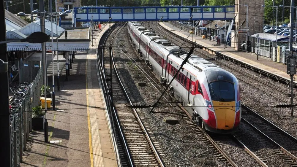 LNER Azuma heads south through the station at Huntingdon^ Cambridgeshire^ England HUNTINGDON^ CAMBRIDGESHIRE/UK - October 9^ 2019