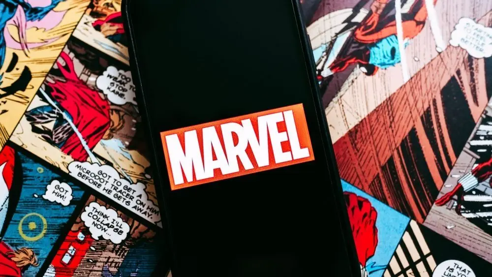 Marvel comics logo on the background of comic pages