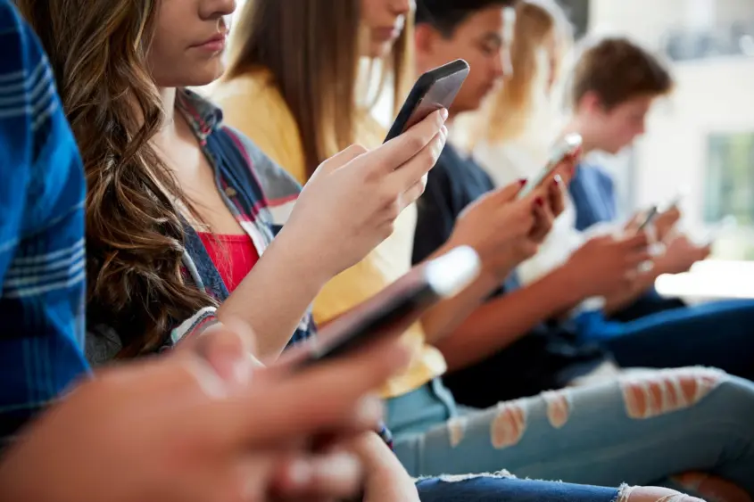 close-up-of-a-line-of-high-school-students-using-mobile-phones-3