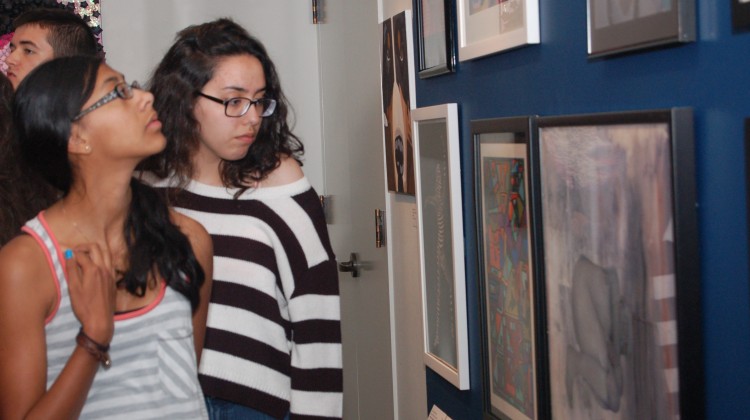 Students review the art selected for the 2014 iCreate exhibition at the Bruce.