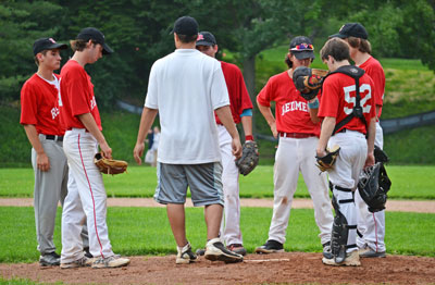 BANC head coach Steve DeRosa talks to his starting pitcher and infield during Monday's game. (Paul Silverfarb photo)