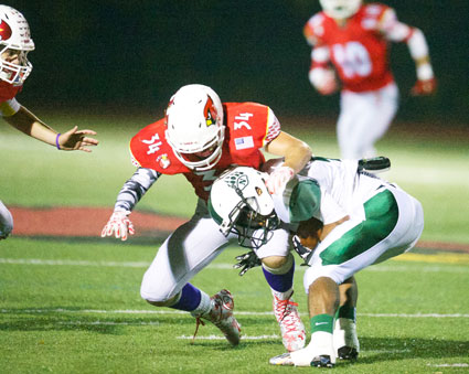 Greenwich's Michael Gianesello applies the tackle during Friday's game under the lights at GHS. (John Ferris Robben photo)