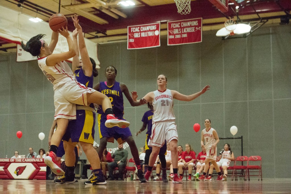 Kim Kockenmeister goes up for a shot as Abbie Wolf positions herself for a rebound in last week's win over Westhill High during a recent game (John Ferris Robbin Photo)