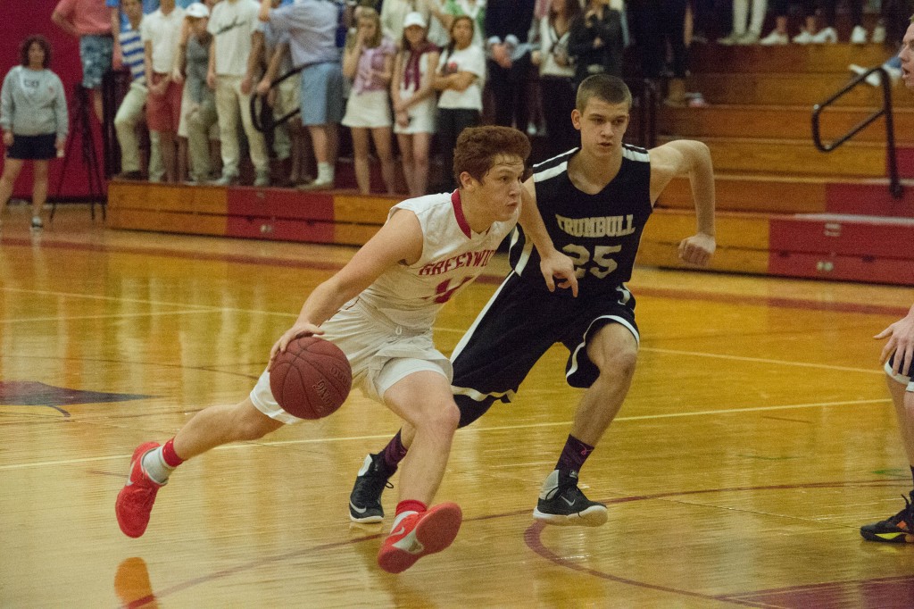 Henry Golden drives by a Trumbull High defender in Tuesday's 69-64 win. (John Ferris Robben Photo)