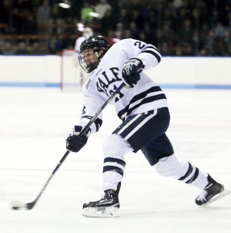 Greenwich native John Hayden fires the puck to the net during a game last season with Yale University. The next time Hayden, a former Brunswick School standout, hits the ice with the Bulldogs, he will have a ‘C’ on his sweater. (photo courtesy of the Yale University Athletic Department)