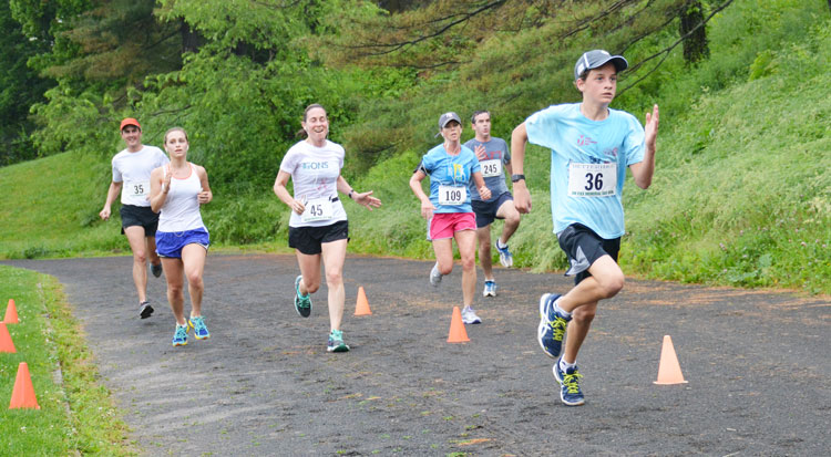 Greenwich resident Peter Kapp, III (36) races to the finish line during the Jim Fixx Memorial Day Road Race. Kapp finished with a time of 39:44 and was tops in the 12-years old and under division. (photo courtesy of Michael Yardis / Threads and Treads)