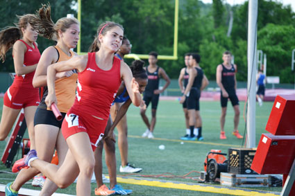 Big Red's Emily Phillippides takes to the track during the 4x400-meter relay race at the CIAC state open finals. (Paul Silverfarb photo)