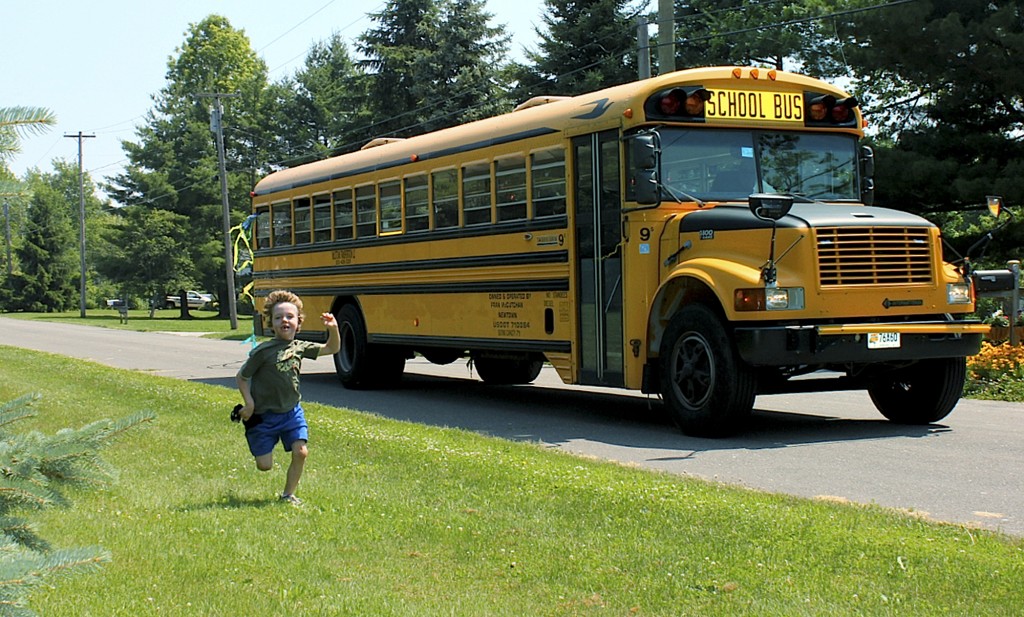 In this 2011 photo provided by Mark Barden, his son Daniel Barden runs alongside a school bus in Newtown, Conn. Daniel was among those killed during the Sandy Hook Elementary School shootings on Dec. 14, 2012, in Newtown. Mark Barden is one of the subjects in the documentary "Newtown," which debuted earlier this year at the Sundance Film Festival. Its first public showing in Connecticut will be at the Greenwich International Film Festival, which begins on Thursday, June 9, 2016, in Greenwich, Conn. (Mark Barden via AP)