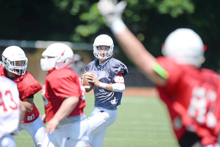 Greenwich High School upcoming senior Connor Langan looks to fire the ball to his wideouts during the annual scrimmage between the GHS Red and GHS White teams Saturday morning. (John Ferris Robben photo)