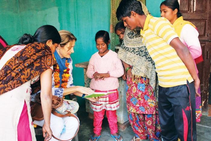 Robin, World Vision Fairfield County, sharing photos with her sponsored child and her family in Agra, India. (contributed photo)