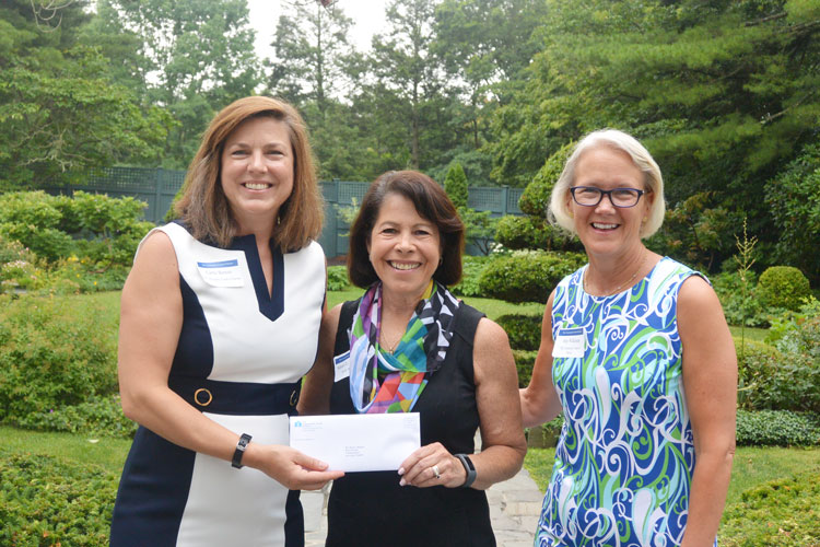 Shari Shapiro, Executive Director of Kids in Crisis, center, receives a check from Carrie Bernier (l) and Amy Wilkinson (r) of The Community Fund of Darien.