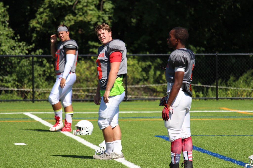 Greenwich High Football Captains Tyler Farris, Paul Williams and Ben Kraninger lead a warmup drill at Monday's scrimmage game (Evan Triantafilidis Photo)