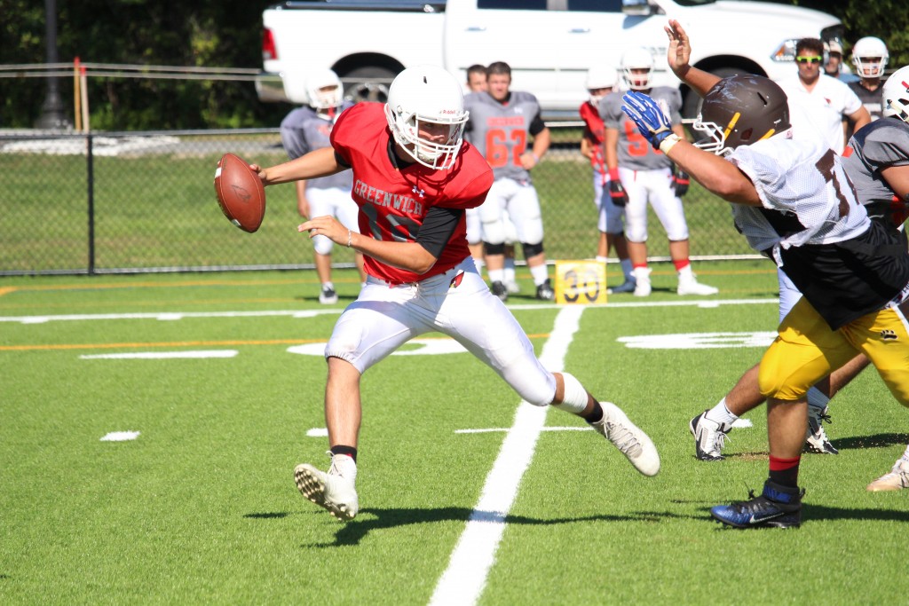 Greenwich High quarterback Connor Langan avoids a defender during Monday's scrimmage (Evan Triantafilidis Photo)