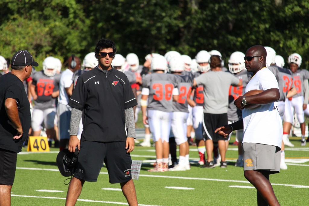 Coach John Marinelli and Jarrett Shine discuss gameplan during Monday's scrimmage (Evan Triantafilidis Photo)