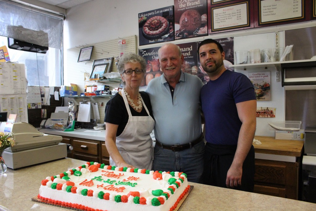 Co-owners Carol Vaccarezza and her husband Vitto, along with longtime employee Angel Marrero, celebrate their last day of business on Wednesday after 28 years in the Old Greenwich community. (Evan Triantafilidis photo)