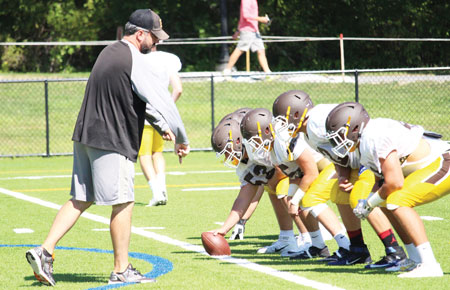 Brunswick School assistant coach Joe Early works with the line prior to the start of a scrimmage against GHS. (Evan Triantafilidis photo)