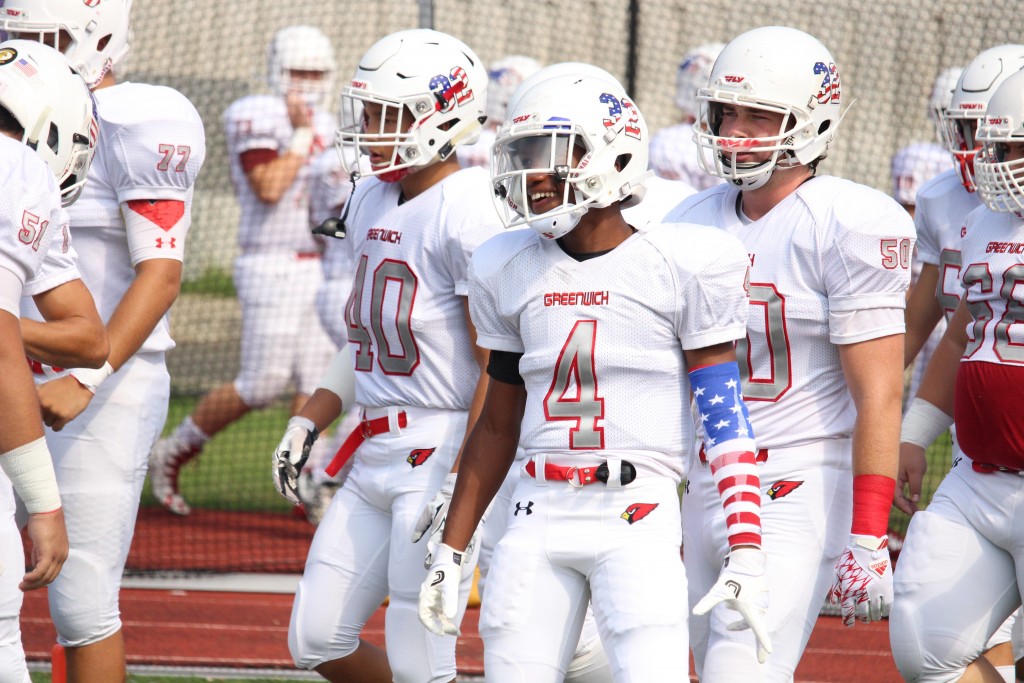 Greenwich senior captain Tyler Farris takes the field with his team on Saturday (Evan Triantafilidis Photo)