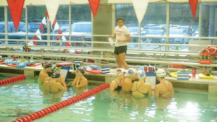 The Greenwich High School girl's swimming and diving team gets some instruction from head coach Lorrie Hokayem prior to the start of Tuesday afternoon's practice at the GHS pool. (John Ferris Robben photo)