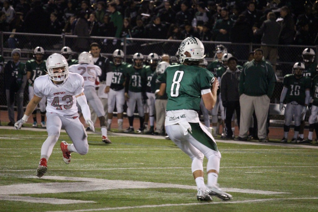 Mike Ceci comes in to pressure Norwalk's quarterback in Friday's 62-34 win. (Evan Triantafilidis Photo)