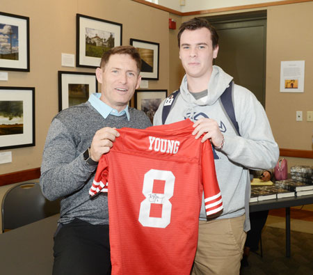 In addition to signing books, Steve Young signed a plethora of other object. Adam Chilvers, a fan of Young, traveled from Cranston, R.I. to get his San Francisco jersey signed by the Hall of Fame quarterback. (John Ferris Robben photo)