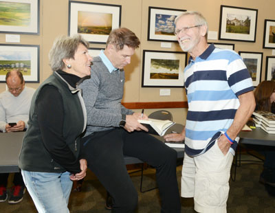 Sue Baker and Terry Lowe, both teachers at Greenwich High when Steve Young was at the school, get an autographed copy of the quarterback's new book. (John Ferris Robben photo)