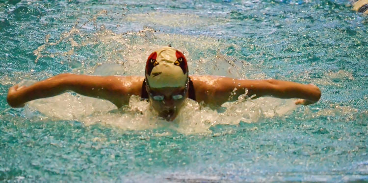 Greenwich High School's Kelly Montesi strikes gold in the 100-yard butterfly event during Saturday's CIAC state open finals at Yale University. (Paul Silverfarb photo)