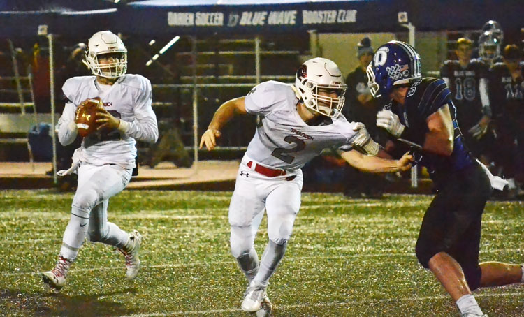 Greenwich High School sophomore quarterback Gavin Muir looks for the open receiver during Tuesday night's CIAC class LL quarterfinal game against Darien. (Paul Silverfarb photo)