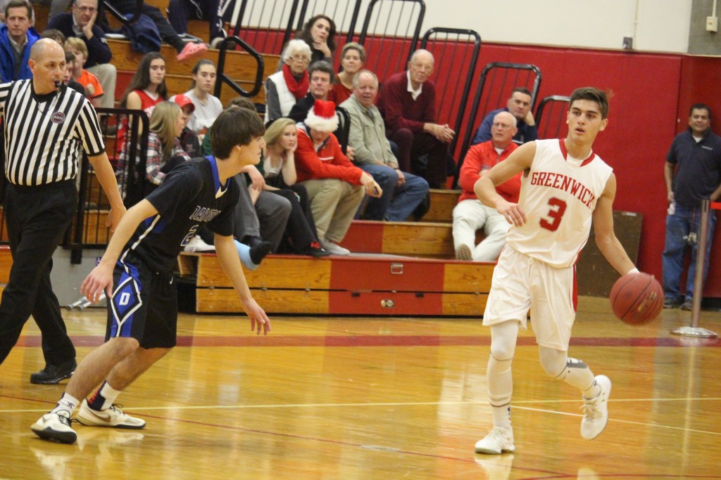 Greenwich point guard Elias Gianopoulos dribbles the ball upcourt against Darien (Evan Triantafilidis photo)