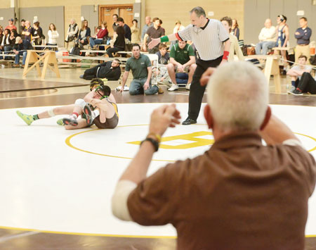 Brunswick School head coach Tim Ostrye looks on as one of his athletes takes to the mat during Saturday's BIT. (John Ferris Robben photo)