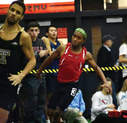 Greenwich High School gold medalist Tyler Farris, a senior, darted around the corner in the finals heat of the 300-meter dash during last week's Fairfield County Interscholastic Athletic Conference championship meet at the New Haven Athletic Center. (Paul Silverfarb photo)