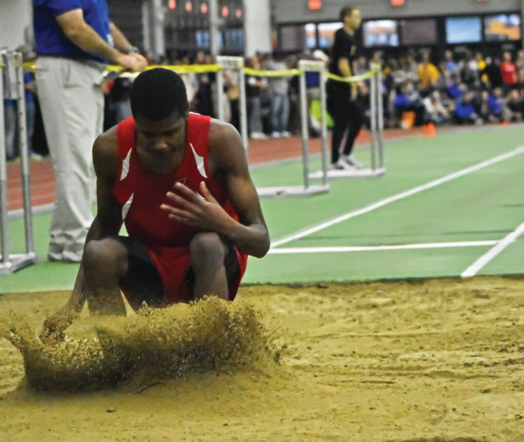 Greenwich High School senior Safir Scott takes second place finish in the long jump during Monday's CIAC state open championship. He bettered himself in the high jump, taking the top spot and gold medal with a height on 11-06. (Paul Silverfarb photo)