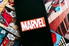Marvel comics logo on the background of comic pages