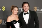 Margot Robbie and Tom Ackerley attend the 2024 EE BAFTA Film Awards at The Royal Festival Hall in London^ England. February 18^ 2024