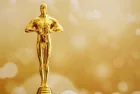Hollywood Golden Oscar Academy award statue on fireworks background. Success and victory concept.