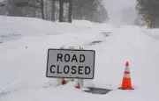 "Road Closed" sign during atmospheric river winter storm event in the Sierra Nevada mountains.