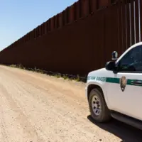 Police car stopped near the border fence of the USA . Arizona^ USA - June 28^ 2016