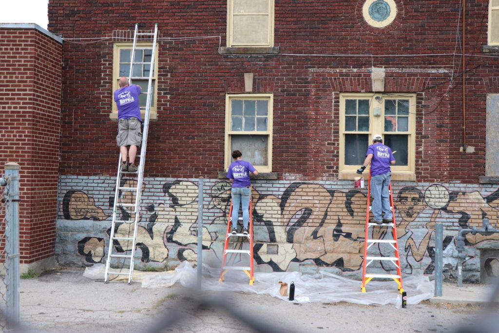 people-painting-building-at-park-2048x1365